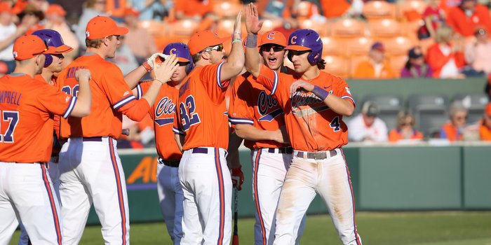 Eli White is congratulated after scoring Clemson's first run (Photo by Dawson Powers)