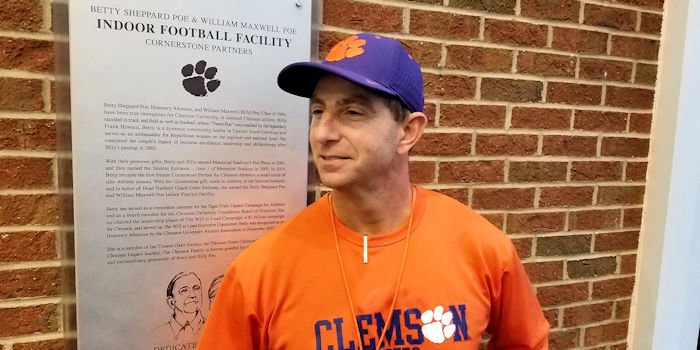 Swinney stands in front of the new plaque Wednesday 