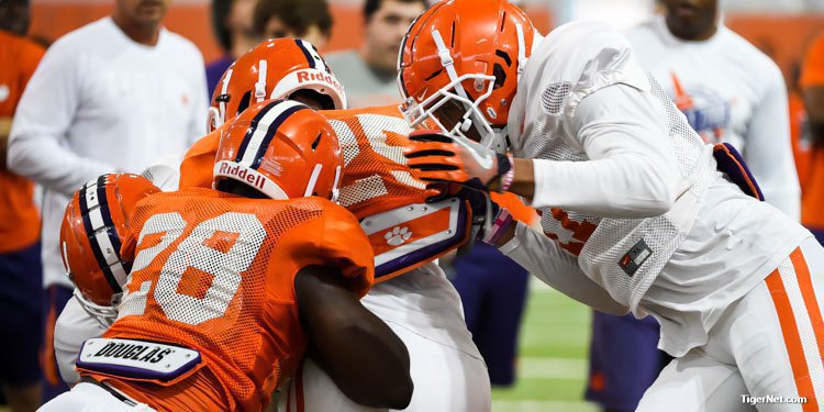 Tavien Feaster runs into a wall of tacklers Tuesday 