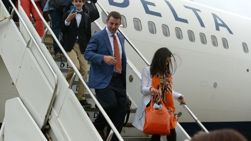 Clemson head coach Dabo Swinney and his wife Kathleen walk off the plane in New Orleans