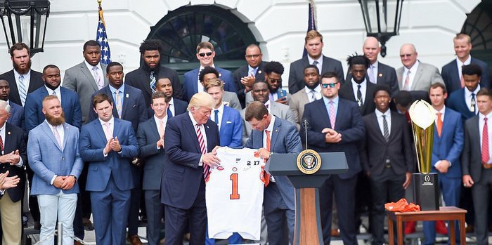 Clemson head coach Dabo Swinney presents a Clemson jersey to President Trump