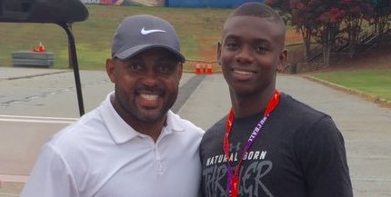 Anthony Cook poses with defensive backs coach Mike Reed last summer 