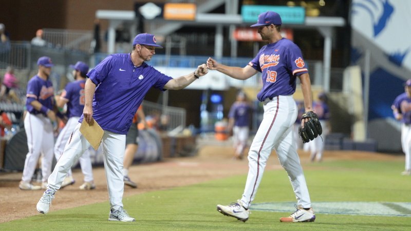 Monte Lee gives a fist bump to Brooks Crawford during Thursday's win over Miami 