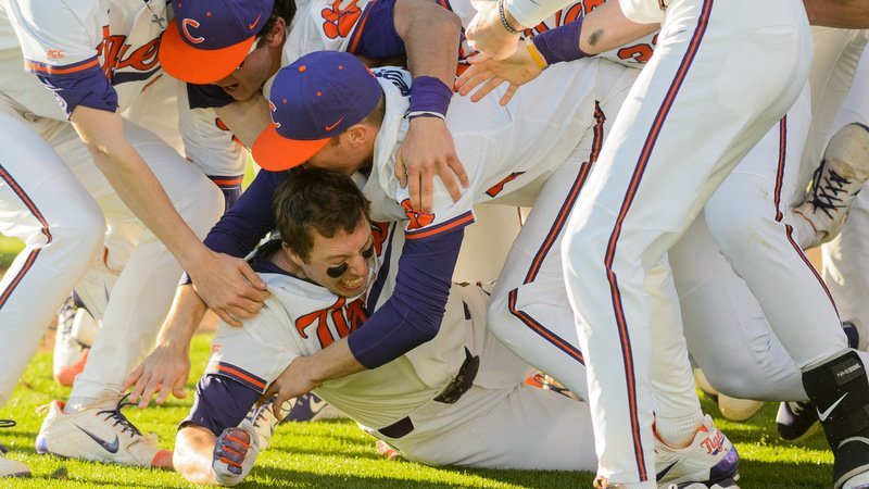 Drew Wharton is mobbed by his teammates after the winning run scored (Photo by David Grooms)