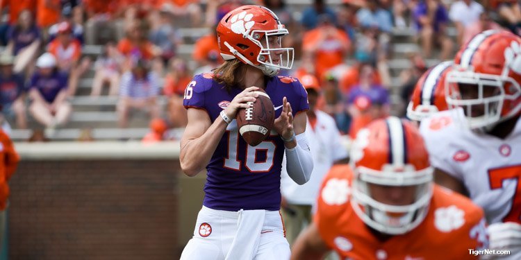 Kelly Bryant throws as Trevor Lawrence looks on 