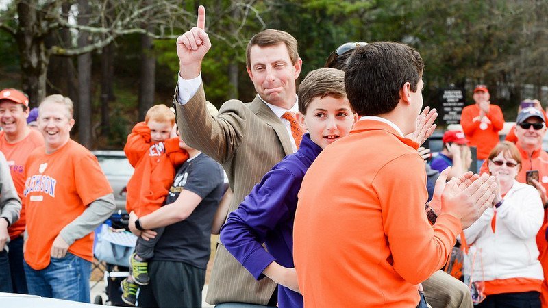 Swinney rides in the championship parade with his family 