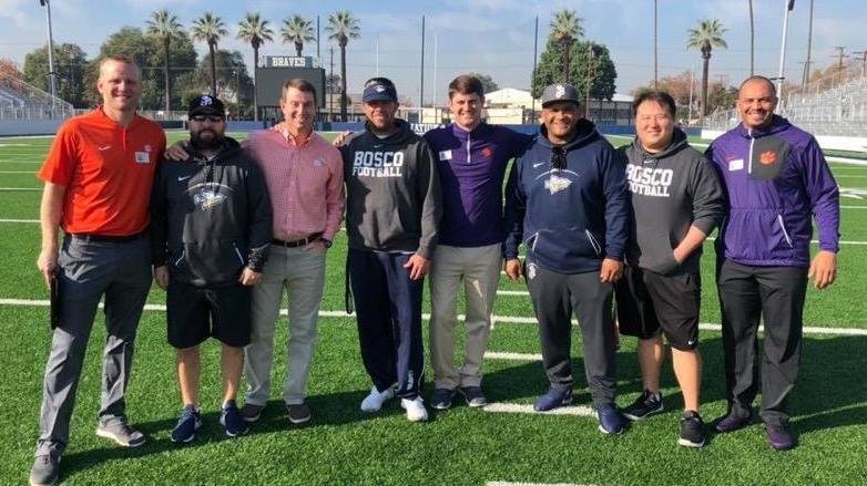 The Clemson and Bosco coaches pose Tuesday at the high school 
