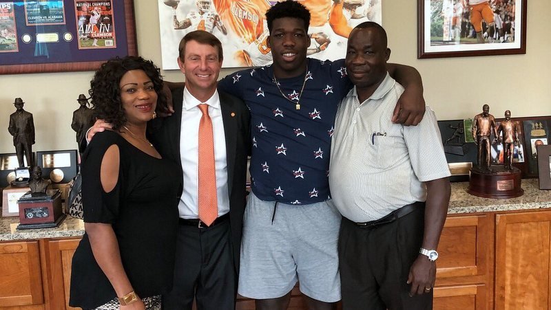 Reuben poses with his family Sunday after committing 