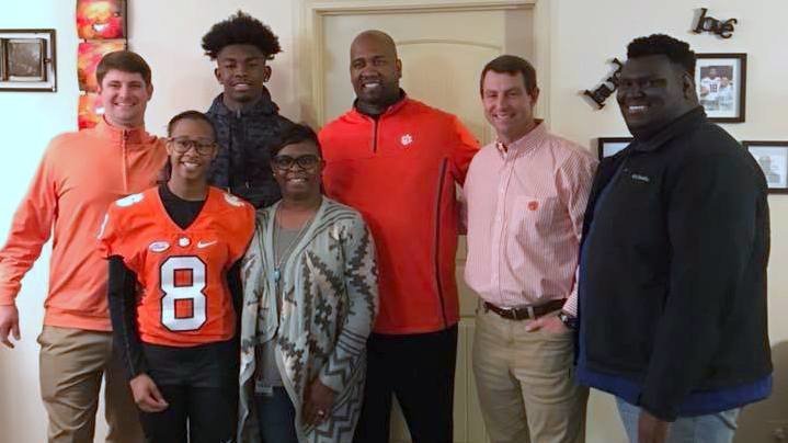 Ross and his family pose with Clemson coaches during the in-home visit 