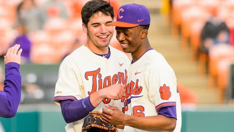 Davis Sharpe greets Askew near the dugout Monday (Photo by David Grooms)