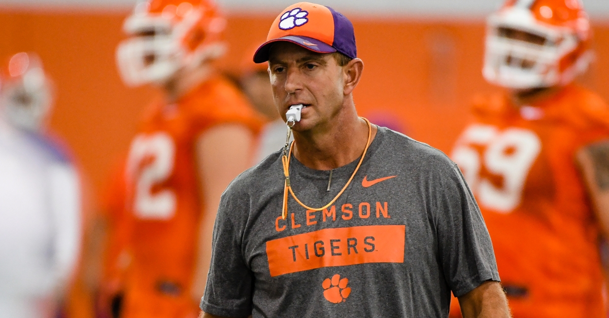 Swinney jots down his lessons on a sheet of loose-leaf paper. 