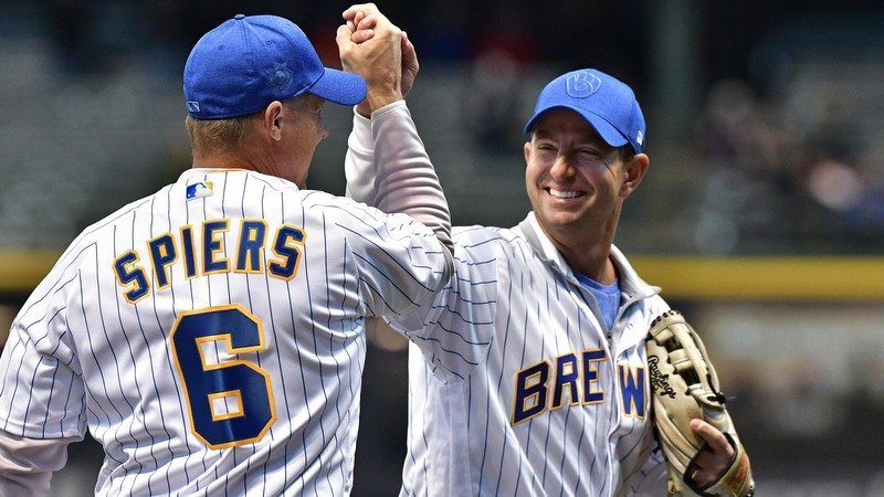 Swinney and Clemson great Bill Spiers exchange a high-five at last week's Brewers game (Photo by Michael McLoone, USAT)