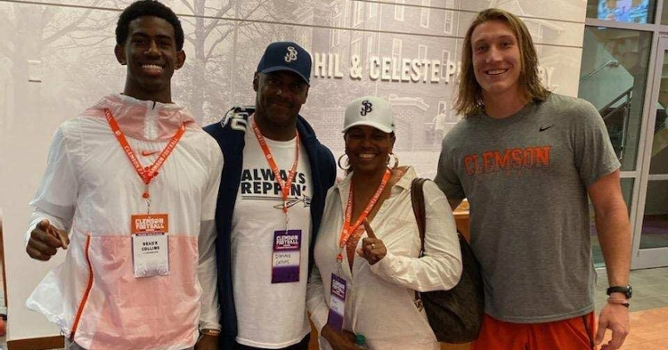 Collins (left) and his parents pose with Clemson quarterback Trevor Lawrence.