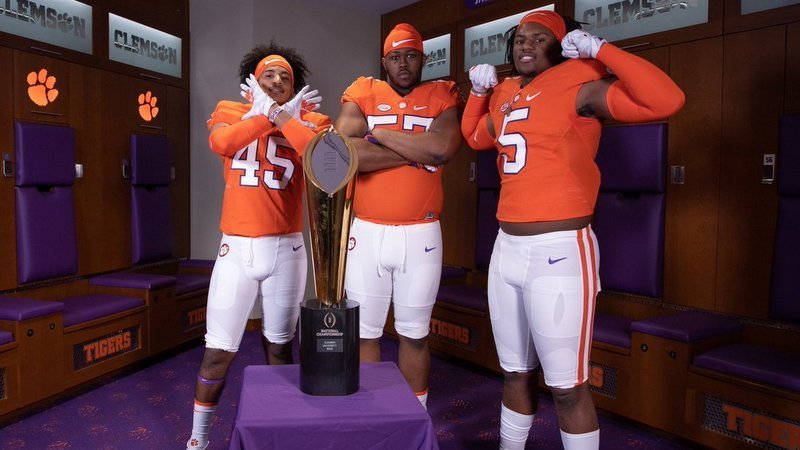 Recruits pose with the National Championship trophy 