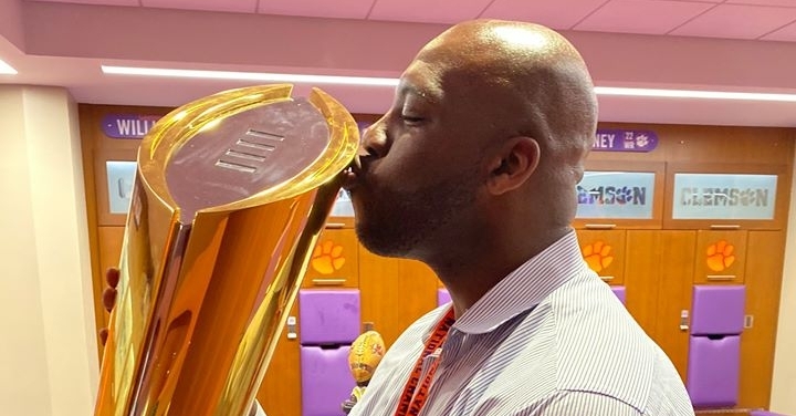 Page kisses one of the championship trophies during the reunion weekend.