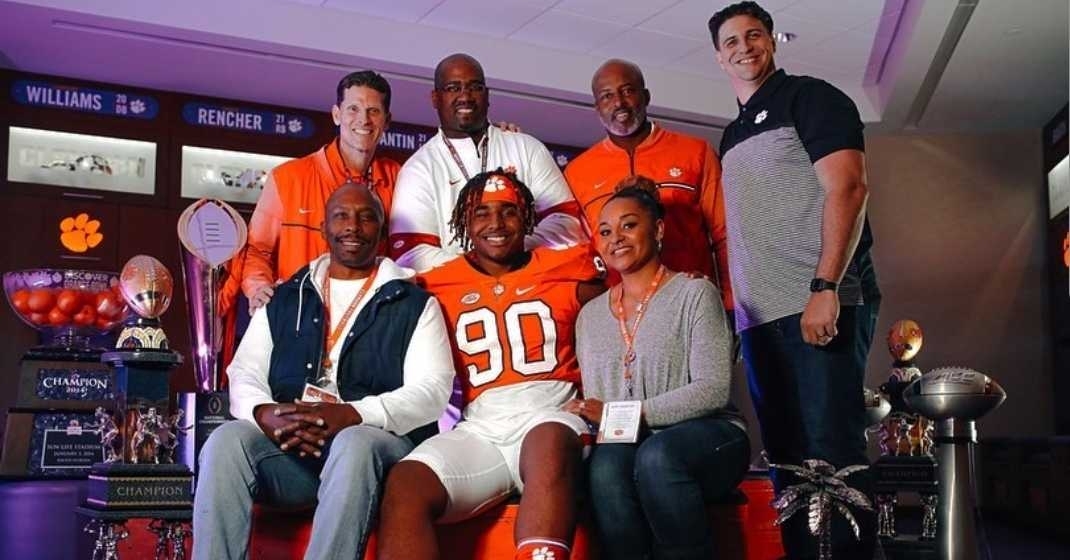 Foreman poses with the coaches and his family in January. 
