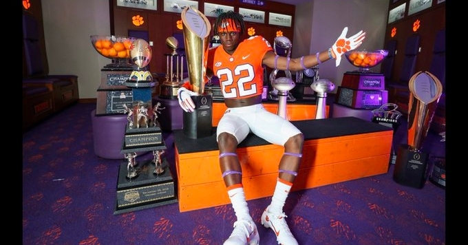 Rucker poses in front of Clemson's impressive array of trophies.