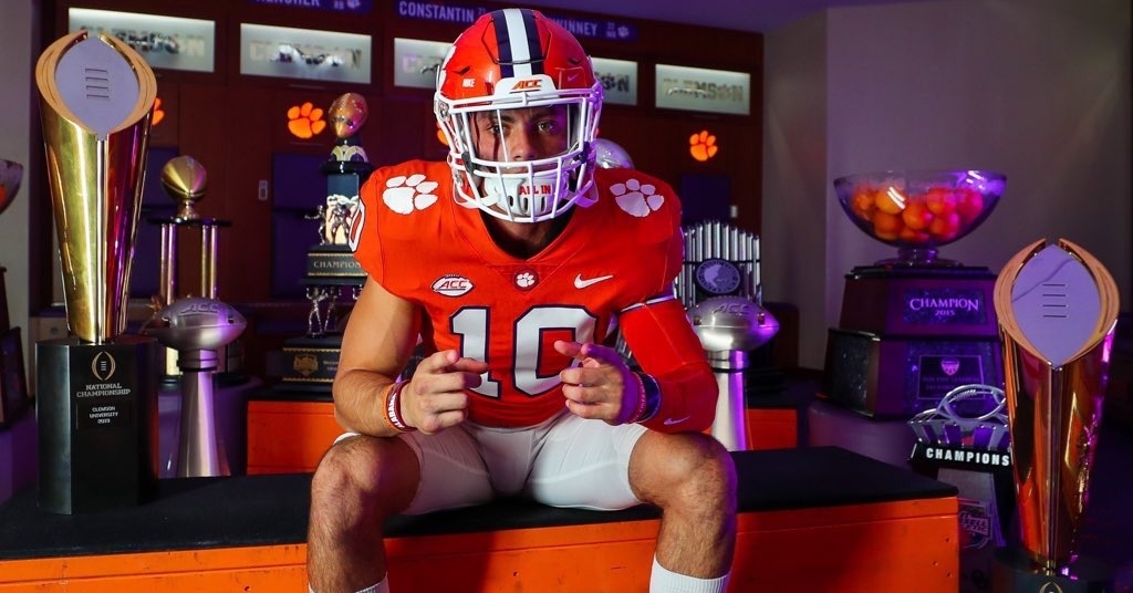 Stellato poses Clemson's trophies on his visit. 